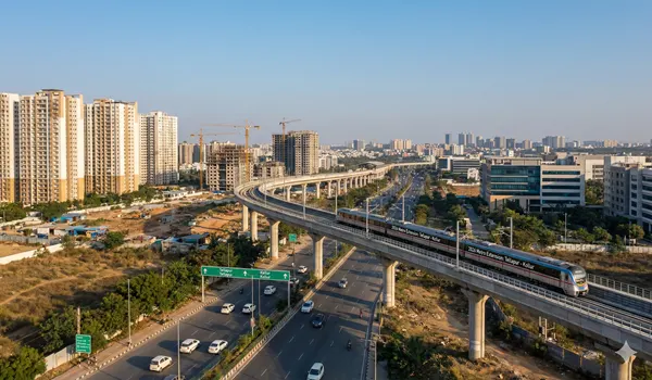 A futuristic digital illustration of a Hyderabad Metro train traveling on an elevated corridor through the skyline of Tellapur and Kollur, featuring modern high-rise apartments and green landscapes, symbolizing the 2026 infrastructure growth in West Hyderabad.
