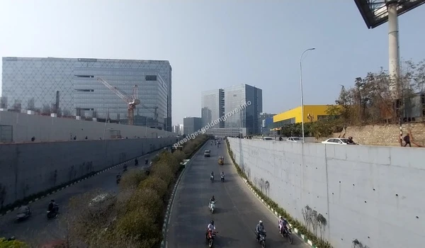 Modern diamond-pattern glass facade of the Auro Realty Galaxy Tower under construction near Prestige Golden Grove