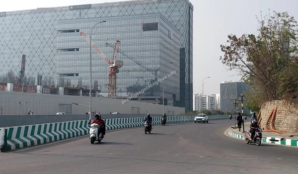 View of the massive Auro Realty Galaxy Tower under construction with cranes visible near Prestige Golden Grove
