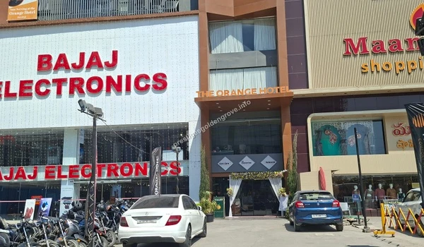 Large Bajaj Electronics retail showroom situated next to The Orange Hotel, showcasing the premium shopping and hospitality options near Prestige Golden Grove