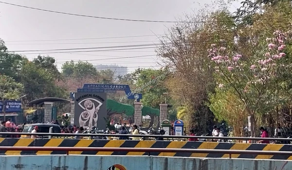 Scenic wide view of the Botanical Garden facade near Prestige Golden Grove in Bangalore, featuring blooming trees and a serene natural environment