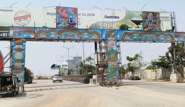 A beautifully decorated overhead transit arch featuring traditional motifs observed on March 03 , 2026, situated on the primary commuting route from the Nehru Outer Ring Road towards Prestige Golden Grove.