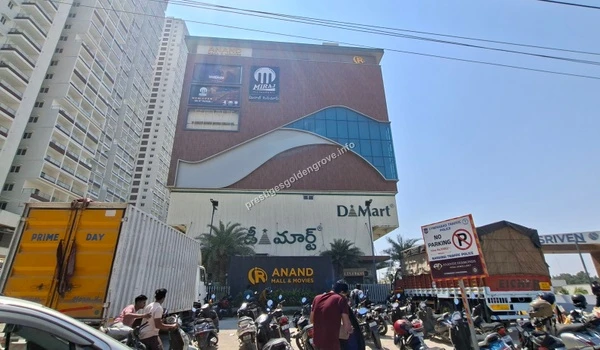 A bustling commercial complex showing the prominent DMart grocery store and multiplex, highlighting the unparalleled daily convenience near Prestige Golden Grove