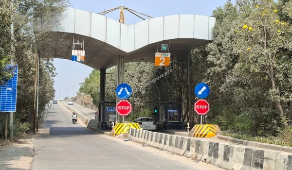 Wide, modern road infrastructure featuring a FASTag-enabled toll gate, highlighting the quick and traffic-free commuting options around the Prestige Golden Grove area