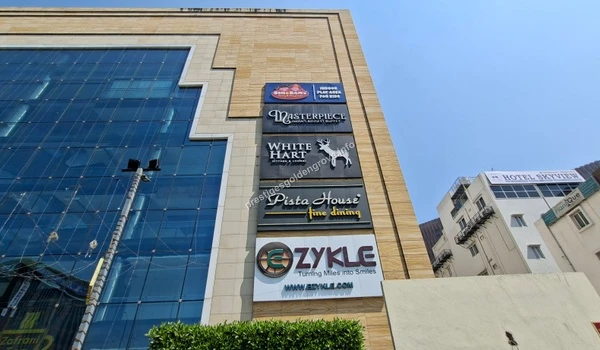 Modern Fortune Cyber commercial building featuring luxury brands like Malabar Gold & Diamonds and Joyalukkas, enhancing the upscale neighborhood of Prestige Golden Grove