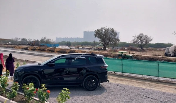 Construction progress at Prestige Golden Grove showing internal road preparation next to a green perimeter boundary net