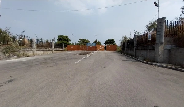 Wide angle view of the main access gate and clear driveway leading into the Prestige Golden Grove premises