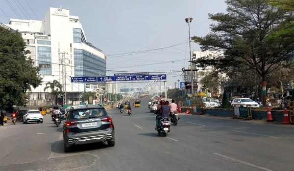Traffic moving through the Marriott Hotel circle area with clear overhead signage towards Hi-Tech City, serving Prestige Golden Grove residents