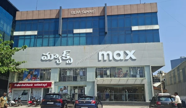 Silpa Summit commercial building featuring a large Max fashion retail outlet and banking facilities, showcasing the developed infrastructure near Prestige Golden Grove
