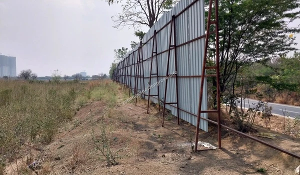 Sturdy corrugated metal barricades installed with iron frames along the main road to secure the Prestige Golden Grove property