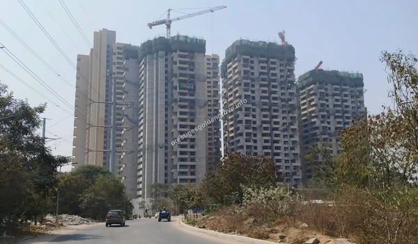 Street view of the expanding neighborhood featuring the Alekhya Rise project and wide access roads near Prestige Golden Grove