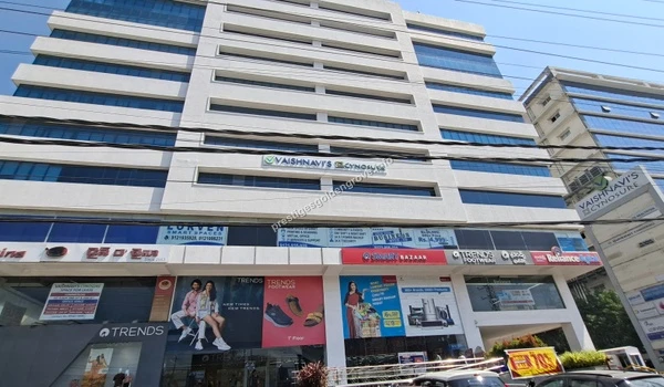 Street view of the bustling commercial building housing Ratnadeep Supermarket and various dining options, offering daily conveniences near Prestige Golden Grove