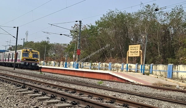 View of the Telapur Railway Station with an arriving local train, highlighting the excellent rail connectivity and daily commuting options available near the Prestige Golden Grove residential project