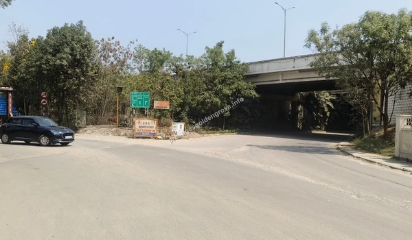 A clear view of the paved access road leading towards the project site on March 03 , 2026, highlighting the excellent infrastructure and underpass connectivity near the Nehru Outer Ring Road for Prestige Golden Grove.