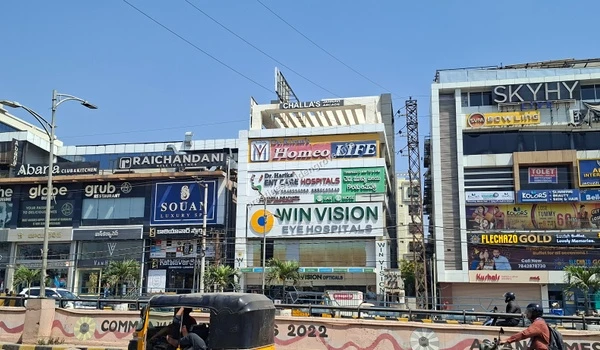Win Vision Eye Hospitals and Homeo Life clinics located in a bustling commercial hub, offering specialized healthcare services close to Prestige Golden Grove