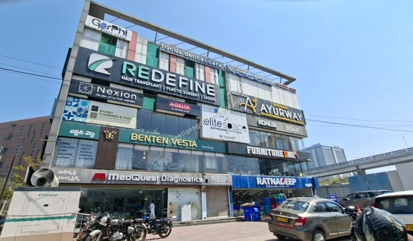 Exterior view of a multi-story retail hub with wellness spas, gaming zones, and family restaurants, located just a short drive from Prestige Golden Grove