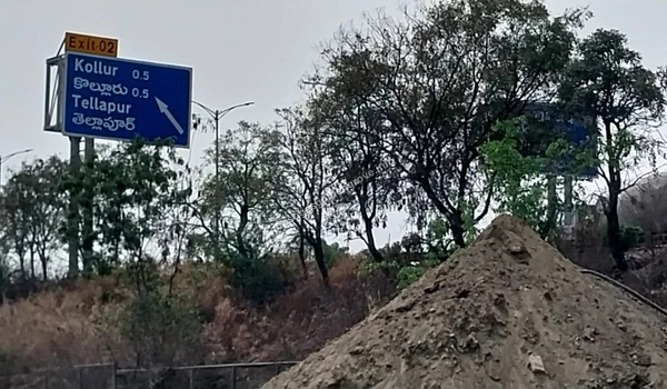 Road signage for Exit 02 directing to Kollur and Tellapur highlighting the prime location and accessibility of Prestige Golden Grove